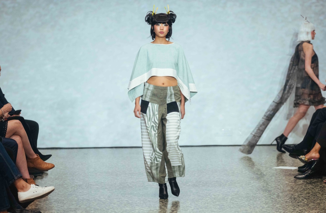 A model walks the runway during a Fashion Fusion event.