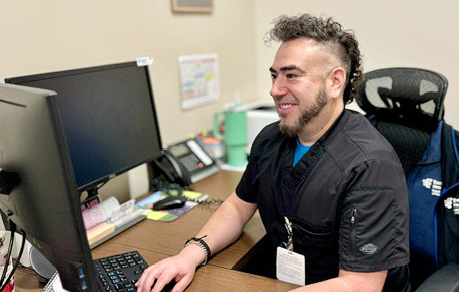 Servando Gonzales III, Healthcare Management BAS student, checks assignments during his lunch break.